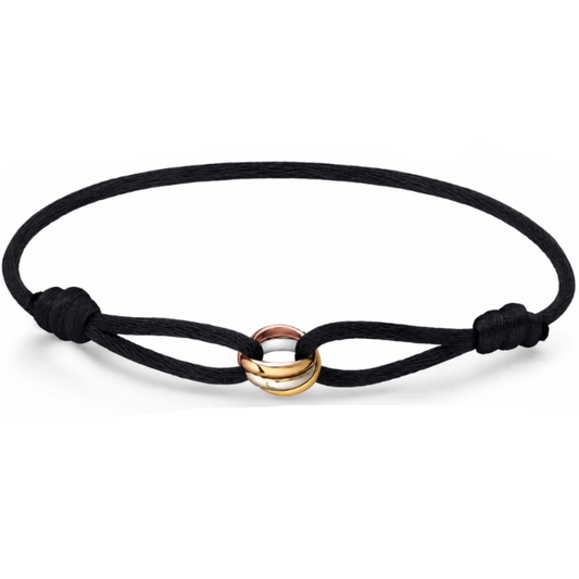 A black cord bracelet with a central double-ring charm in polished gold and rose gold, shown on a clean white background.