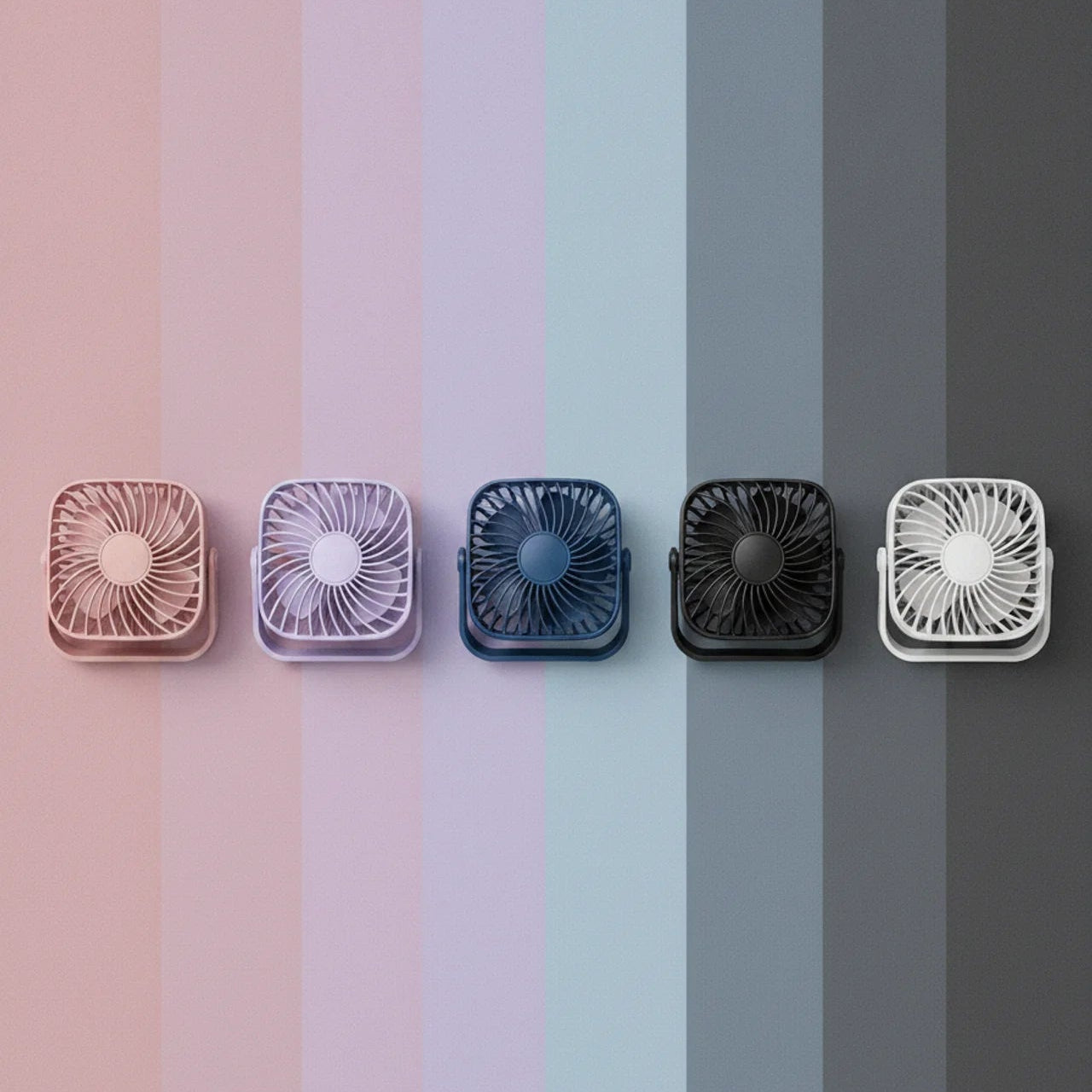 Five small fans of different colors arranged on a gradient background
